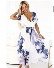Vestido midi vaporoso con estampado azul floral. Elegancia femenina y ligereza. comprar usado  Enviando para Brazil