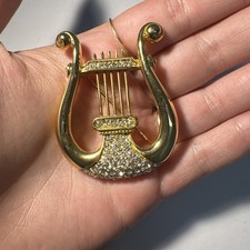 Broche lyre dorée d'occasion  Andernos-les-Bains