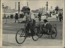 Usado, Foto de prensa 1947 Tokio joven con bebé en la parte trasera paseos en carro de bicicleta. segunda mano  Embacar hacia Argentina