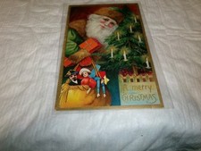Cartão postal antigo de Papai Noel vestido verde e marrom em relevo com brinquedos comprar usado  Enviando para Brazil