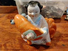 man holding fish statue for sale  Northford