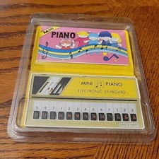 Mini piano vintage amarelo ELECTRON ECHO ANOS 80 com livro de músicas novo no pacote comprar usado  Enviando para Brazil