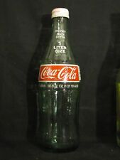 Saia Hobbleskirt Coca-Cola 1 litro, 33,8 oz. (1 qt. Garrafa de refrigerante 1,8 ozs) ACL 1976 com tampa comprar usado  Enviando para Brazil