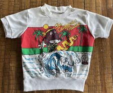 Camiseta vintage para niños pasas californianas década de 1980 talla 5T niños jóvenes surf playa segunda mano  Embacar hacia Argentina